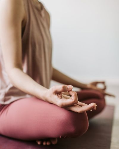Close-up of a person's hands in a meditative mudra pose.